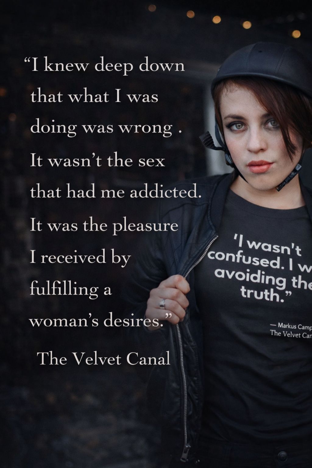 Person wearing a black hoodie with text on it, against a dark background.